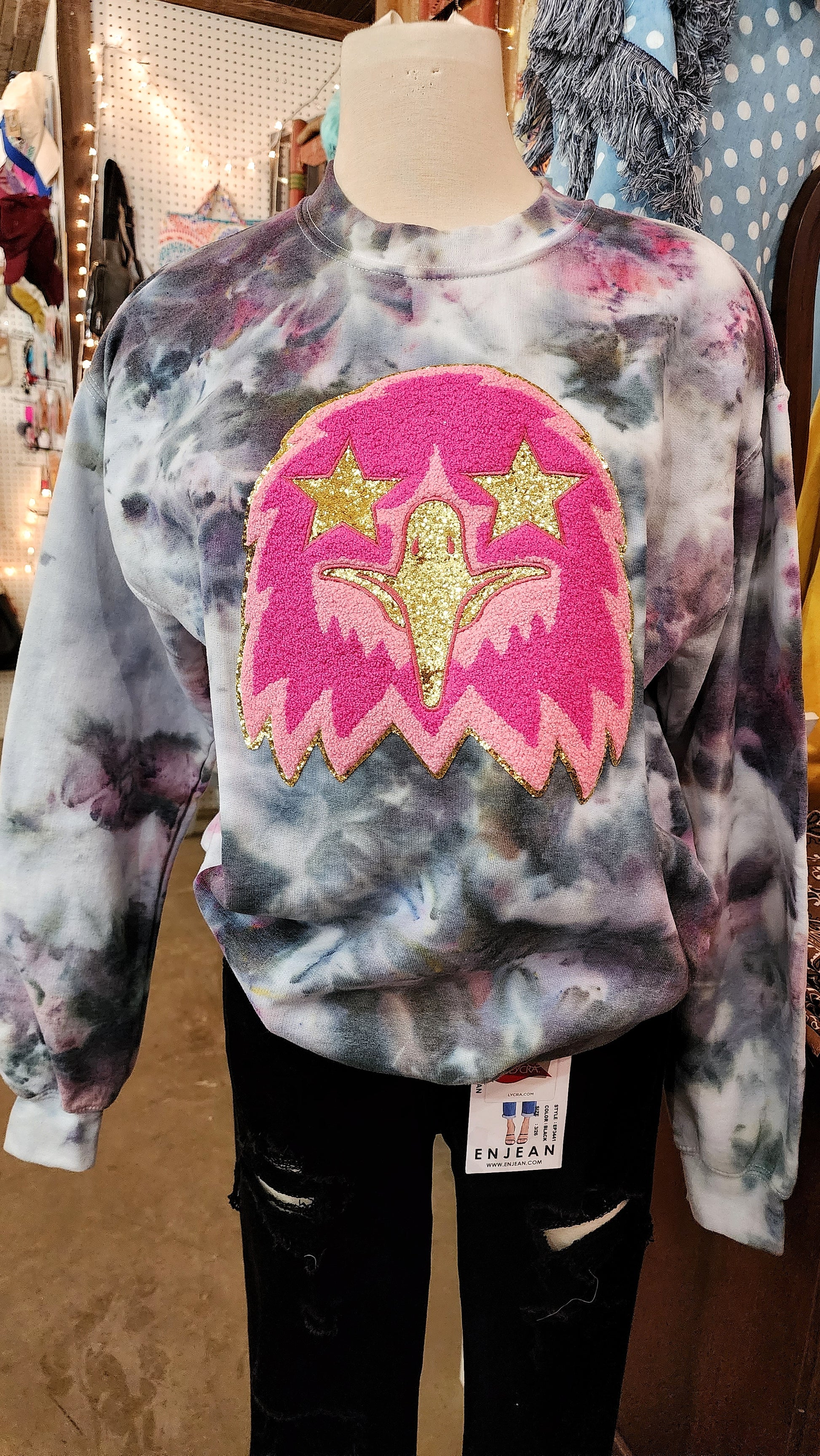 Prepp Eagle Mascot Sweat Shirt - Tie Dyed. Eagle is a two toned pink chenille patch with glitter gold beak and star eyes. Sweatshirt is white with tie dye colors of black, pink, purples, and hints of yellow.